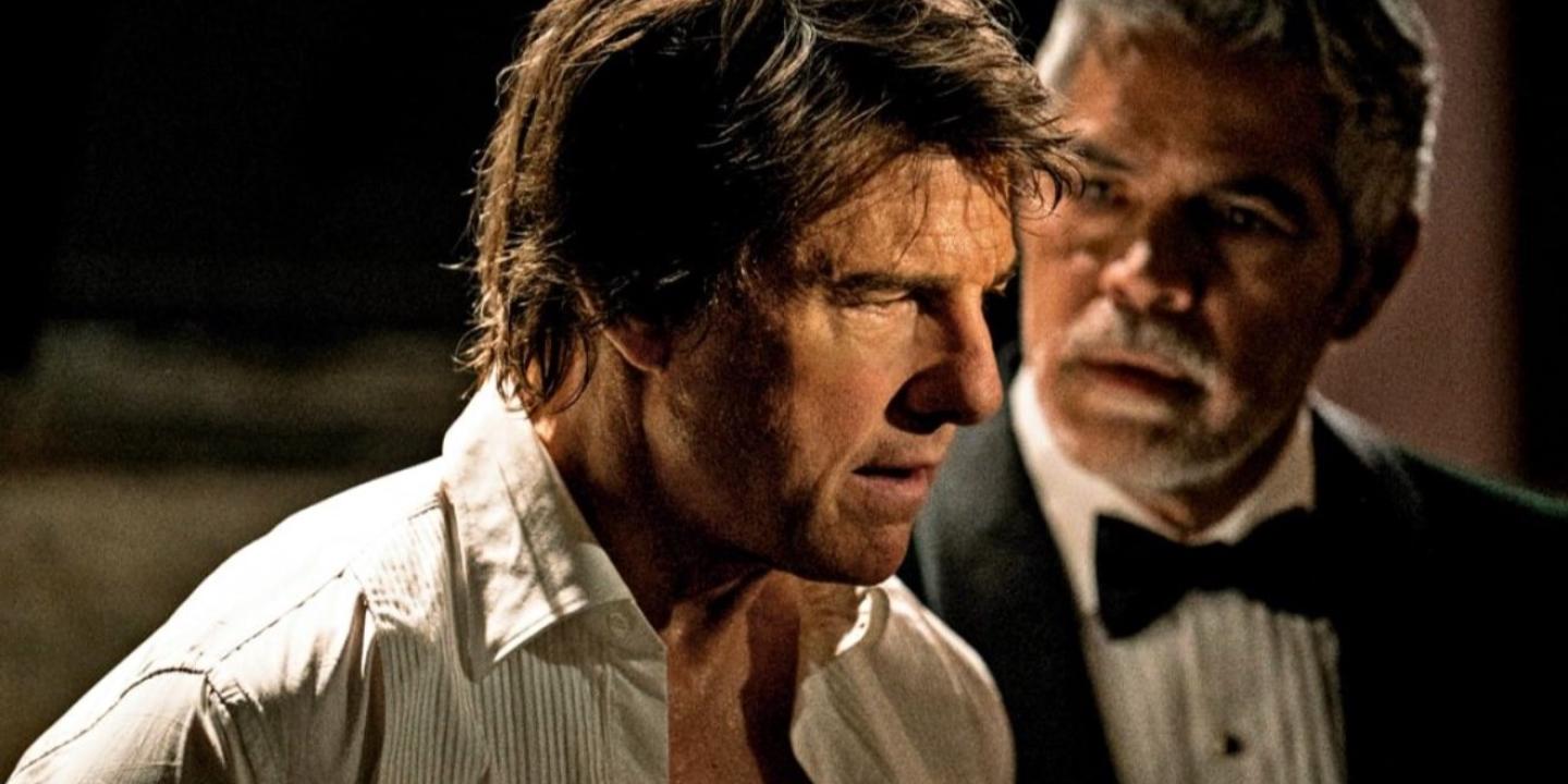 Tom Cruise playing Ethan Hunt in an open necked shirt looks perplexed.