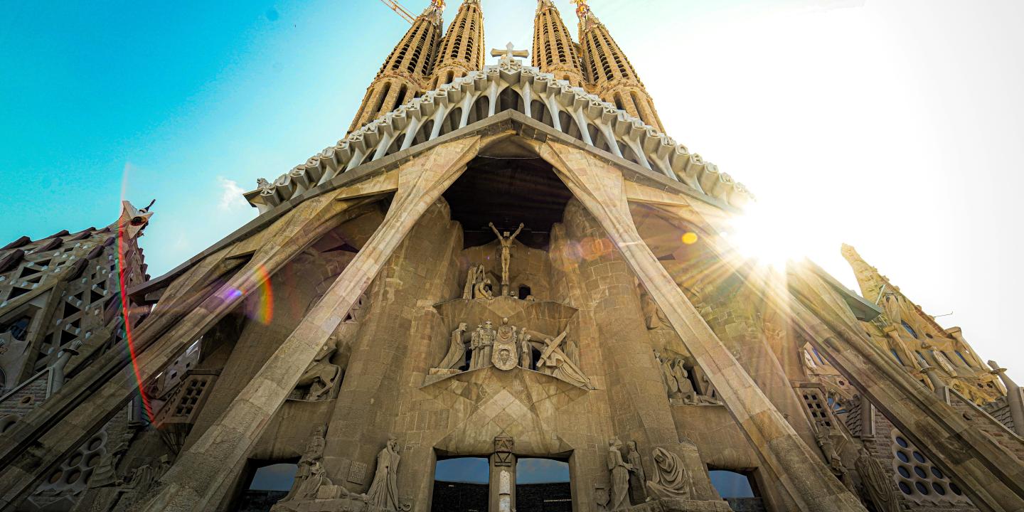 Looking up at the front of Gaudi's cathedra; as the sun comes out from behind the spires.