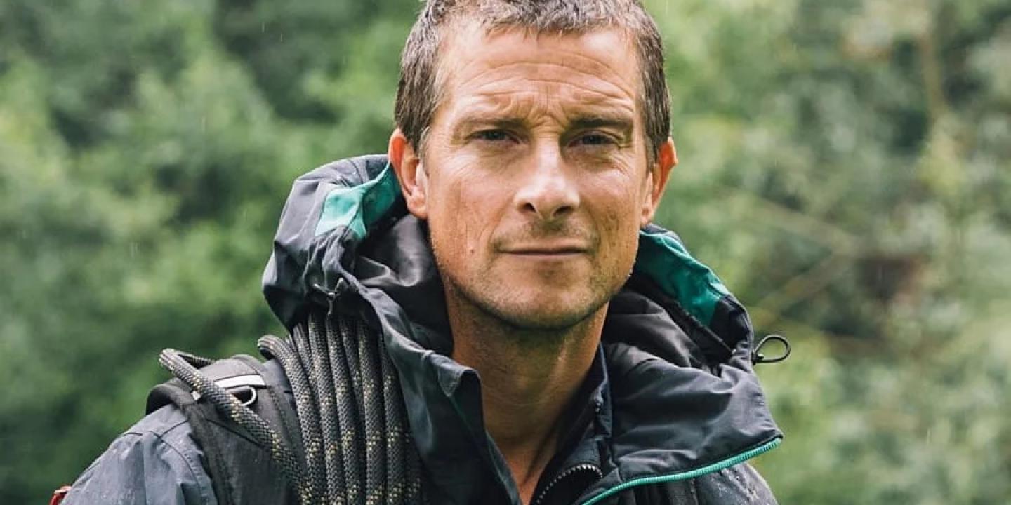 A wet-looking Bear Grylls looks at the camera.