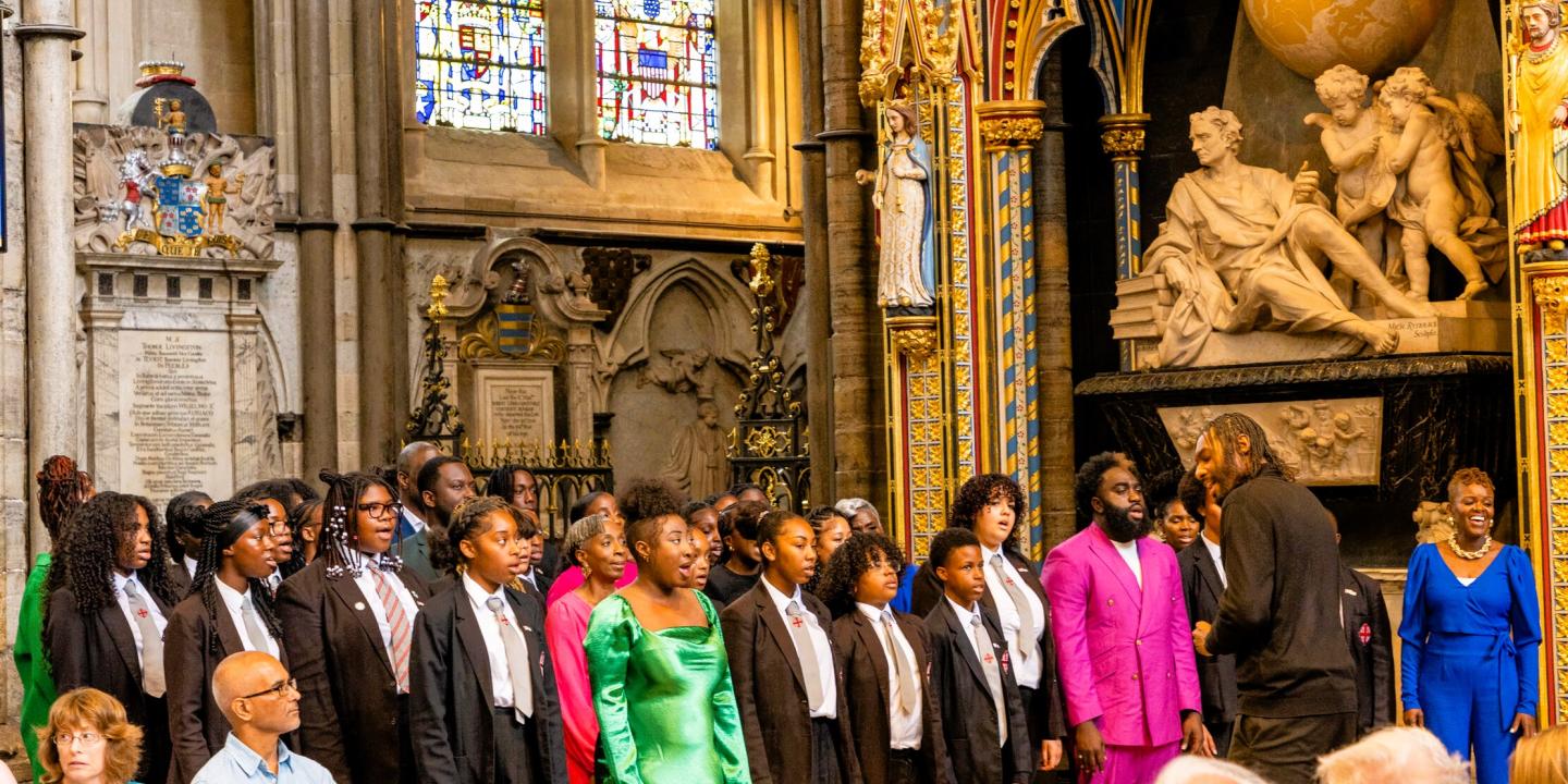 A school choir sings in an ornate abbey setting