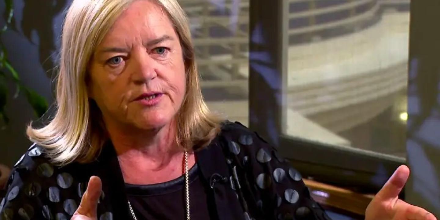 A woman talks in an interivew.