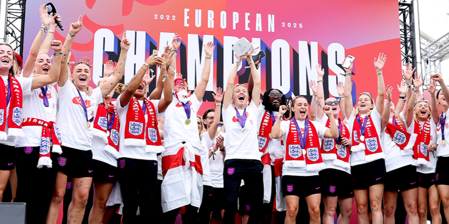 A victorious women's football team celeberate.