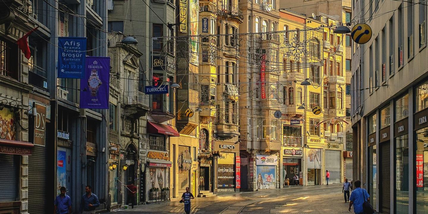 An Istanbul street curves and the sun illuminates one side
