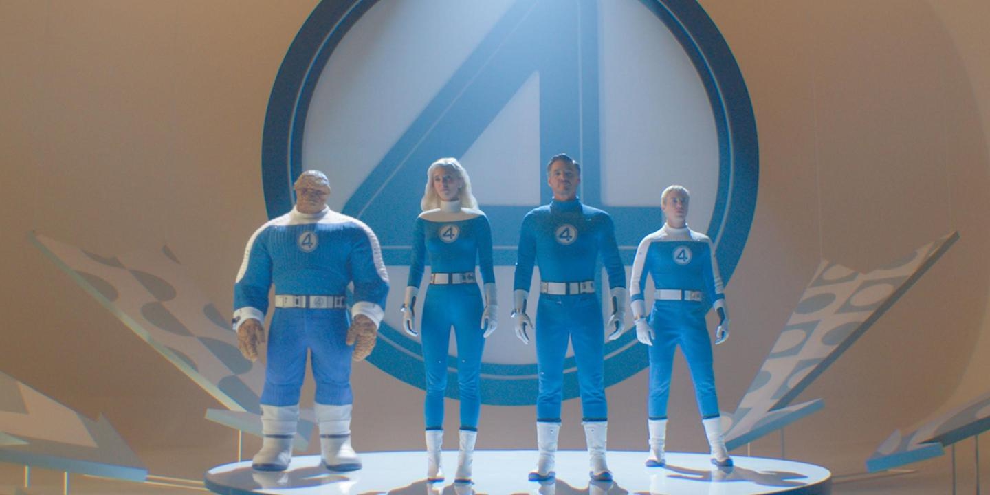 THe Fantastic Four stand on a podium