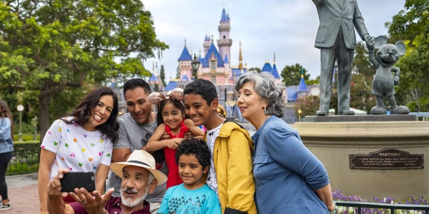 A family pose for a picture at Disneyland