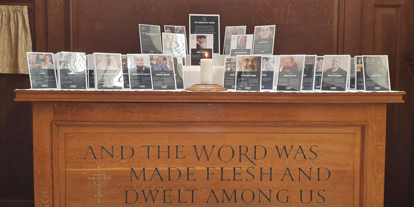 A church altar holds commemorative frames of killed journalists
