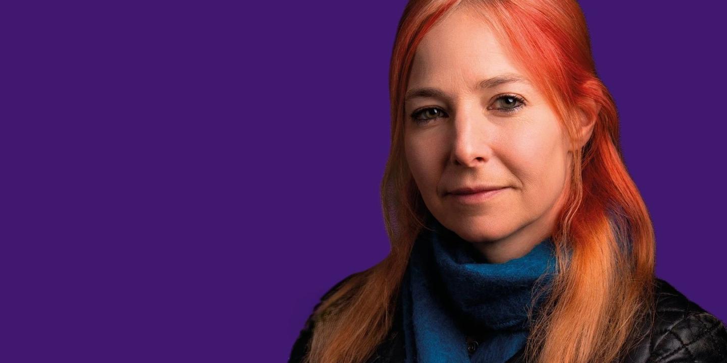 A head and shoulder image of Alice Roberts against a purple background