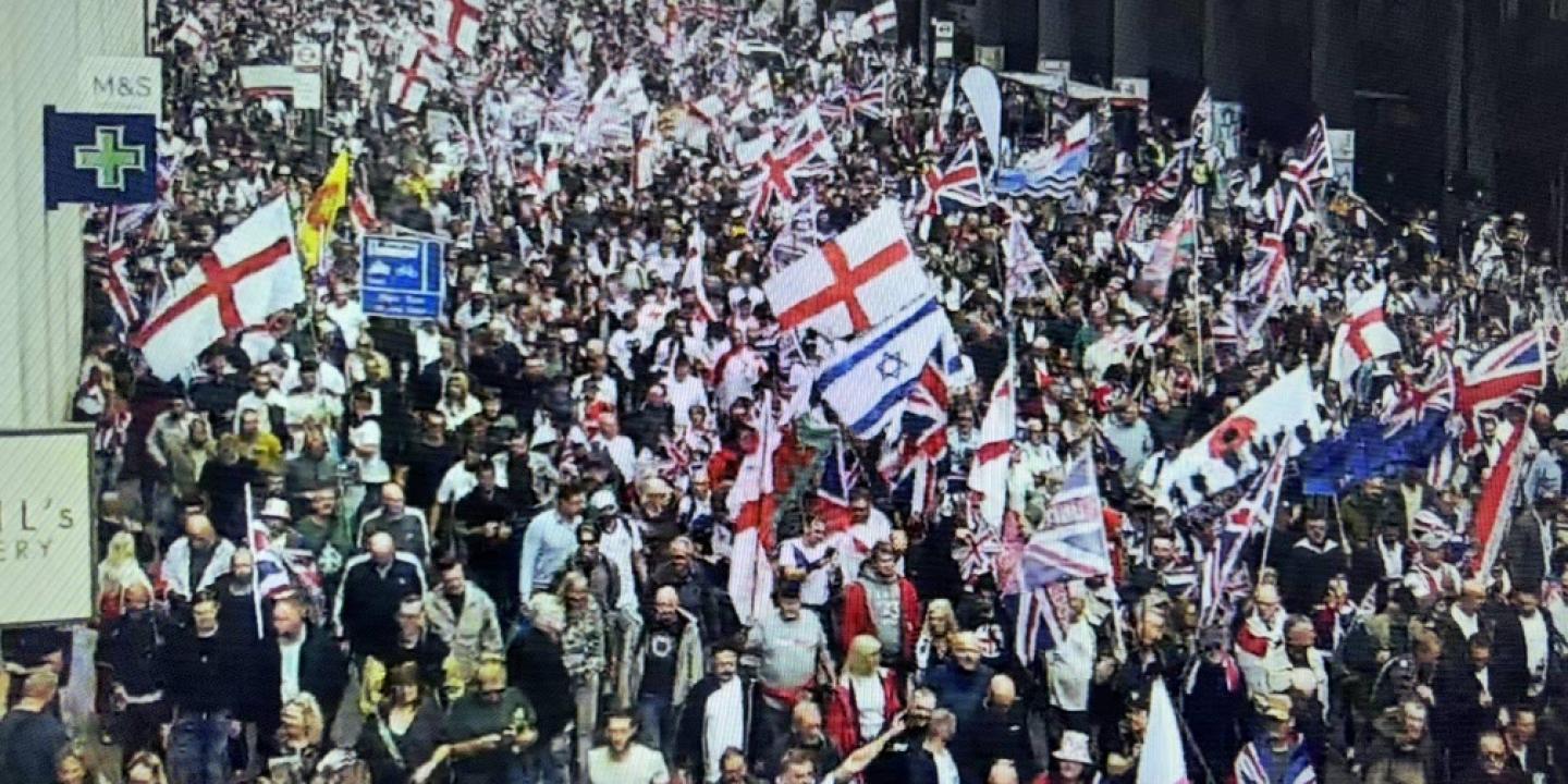 Marchers carry British, English and Israeli flags