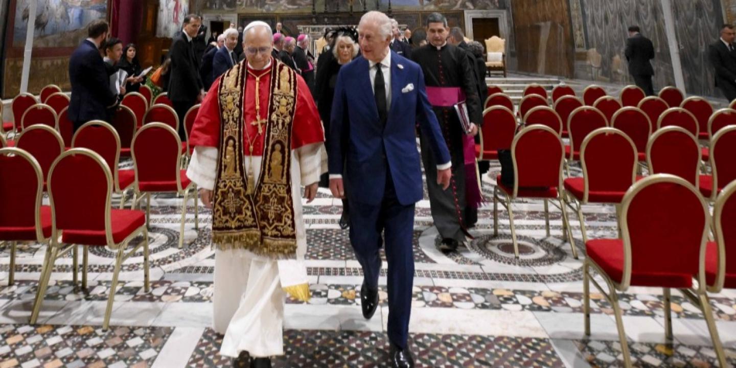 The Pope and King Charles walk together from the Sistine Chapel