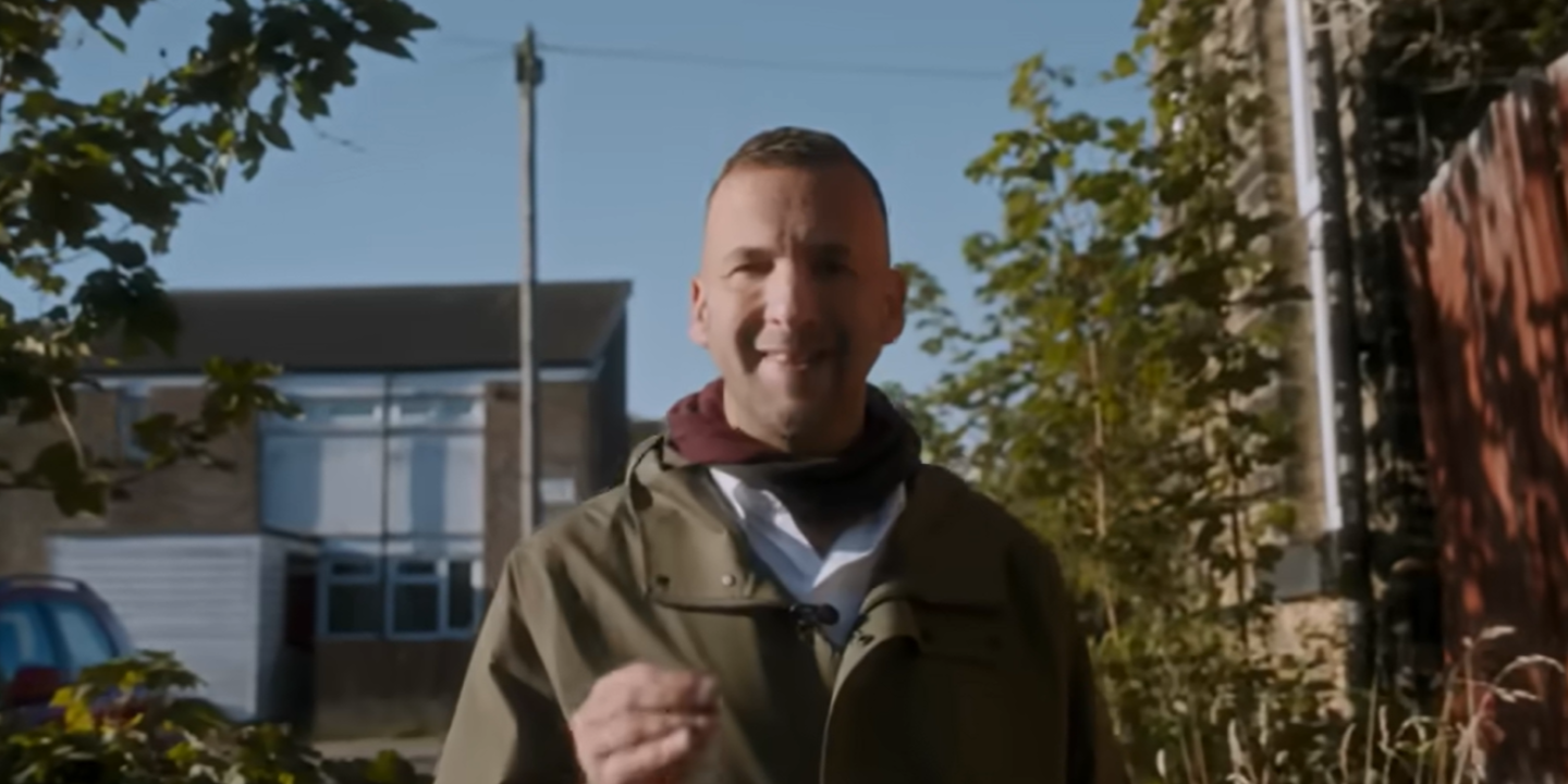 Zack Polanski walks down an alleyway