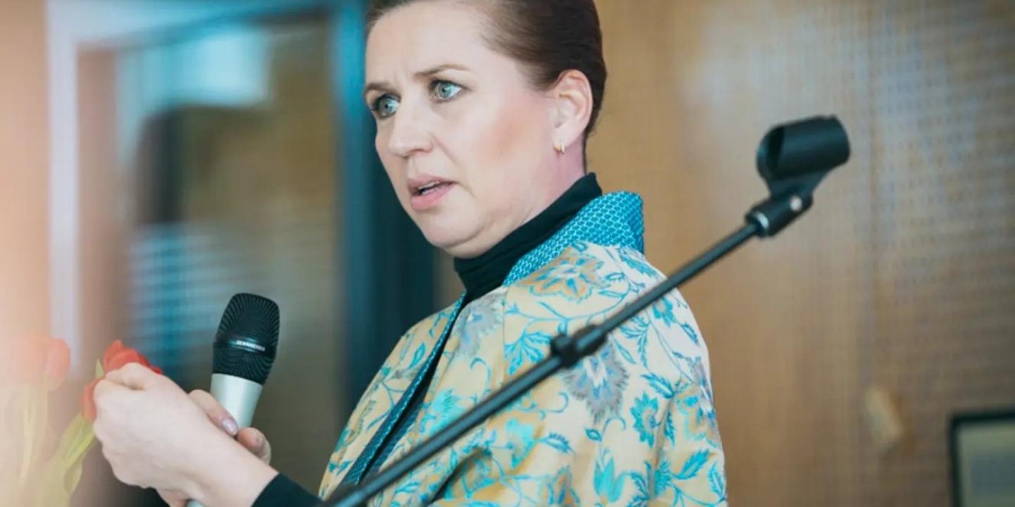 Mette Frederiksen gesture as she delivers a speech. 