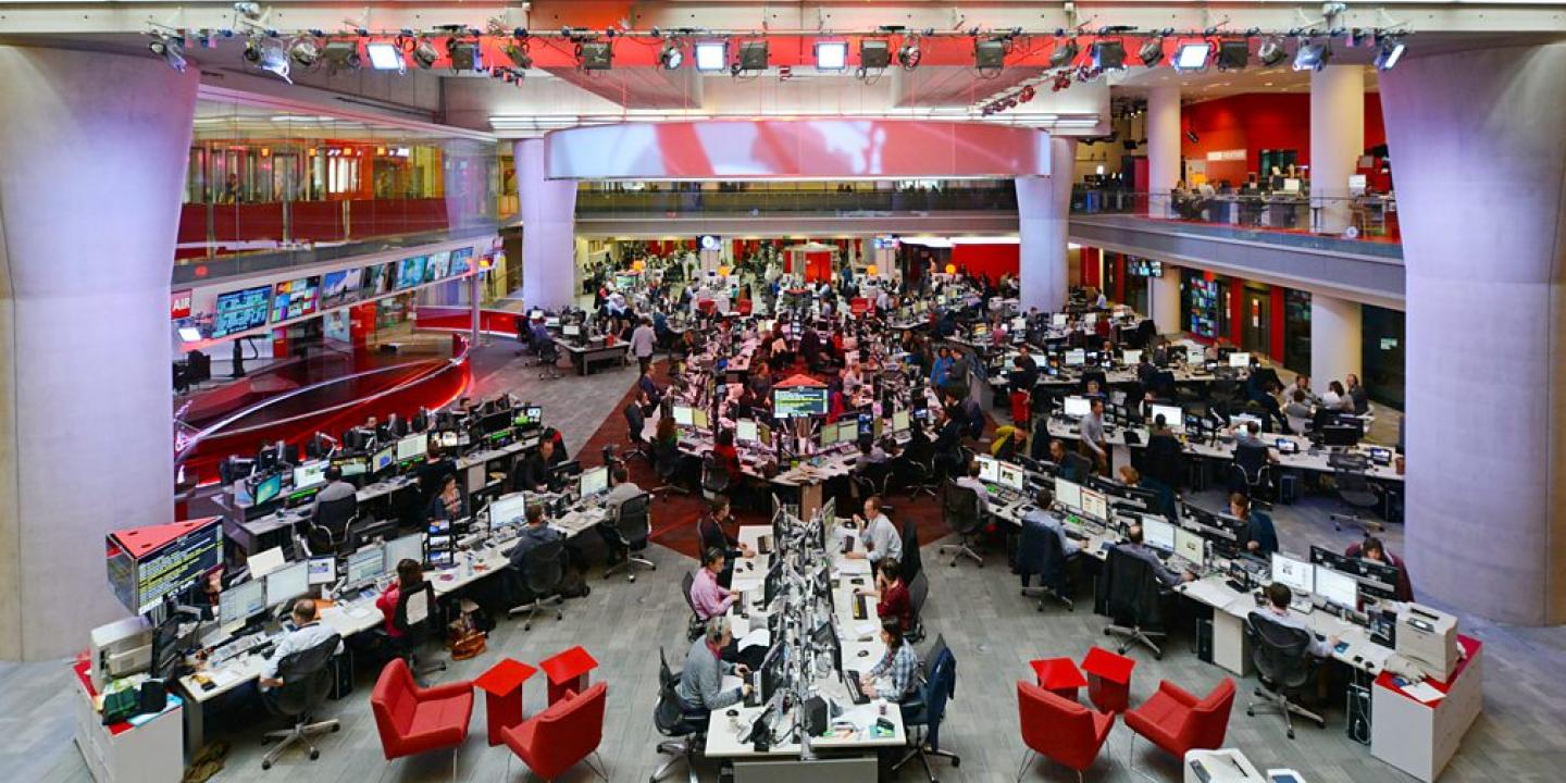 A wide angle view of the BBC newsrooms show a starm layout of desks