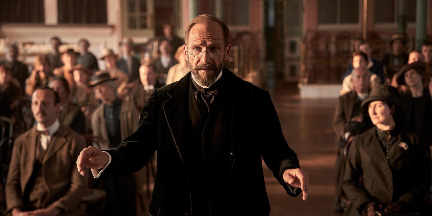 An Edwardian choirmaster conducts.