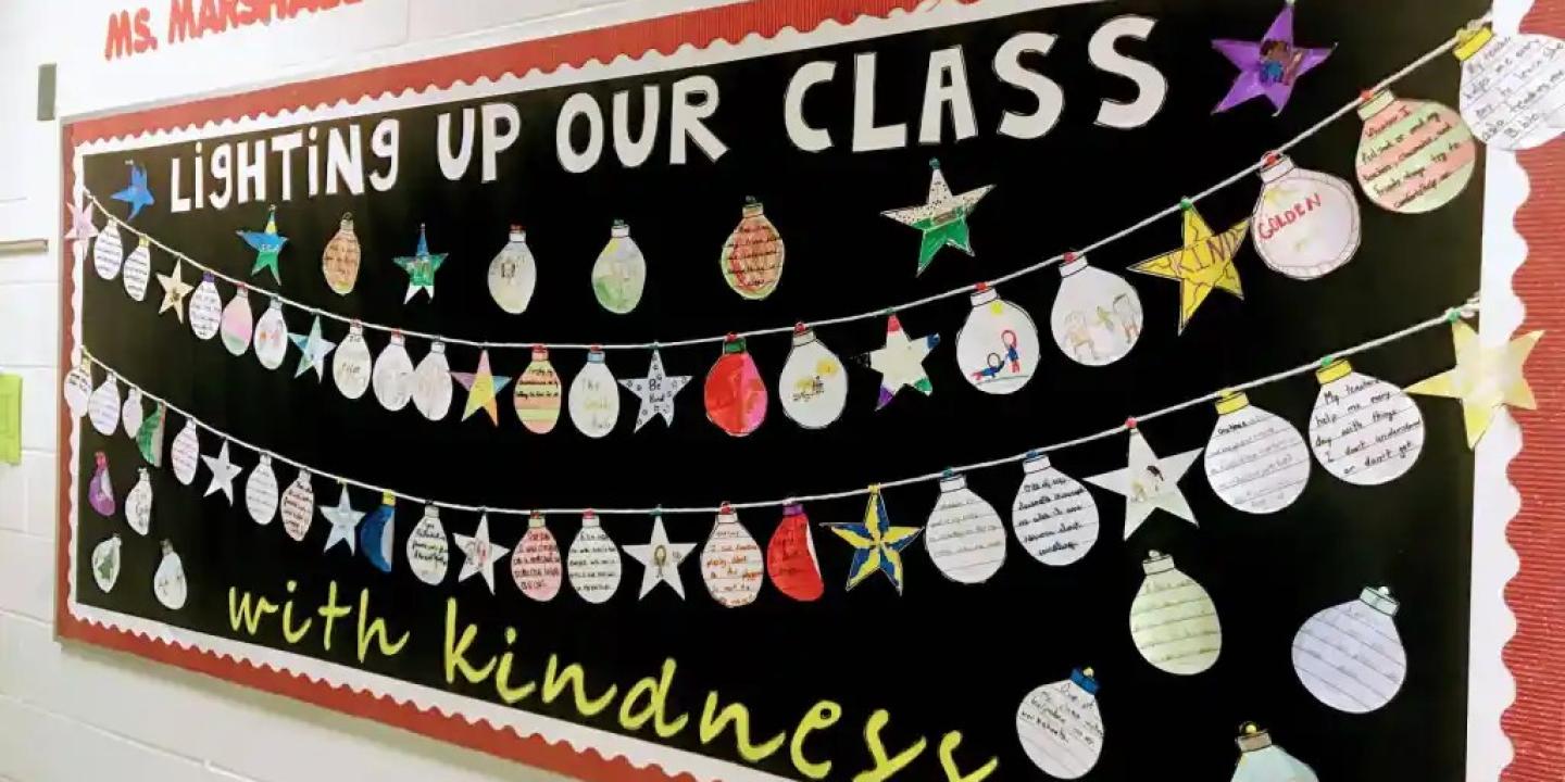A classroom display of Christmas baubles under a banner.