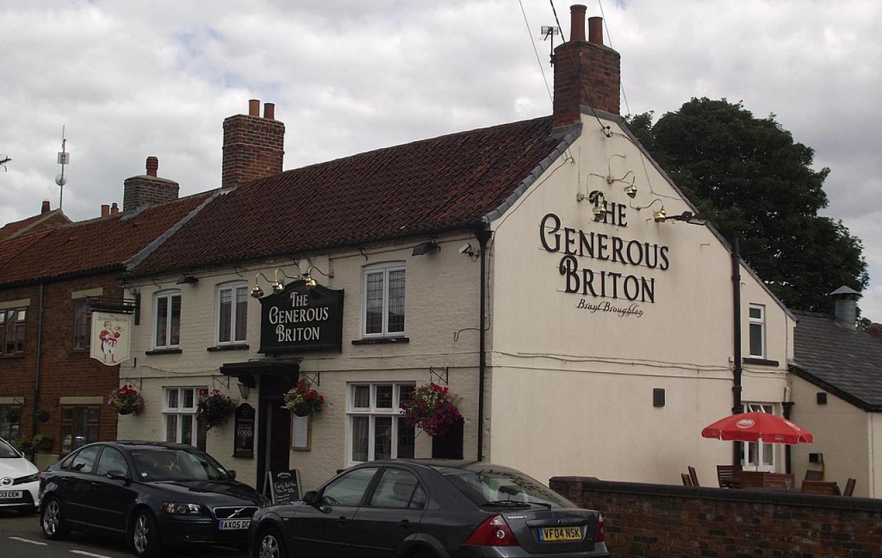 A village pub with its name on the gable end: The Generous Briton