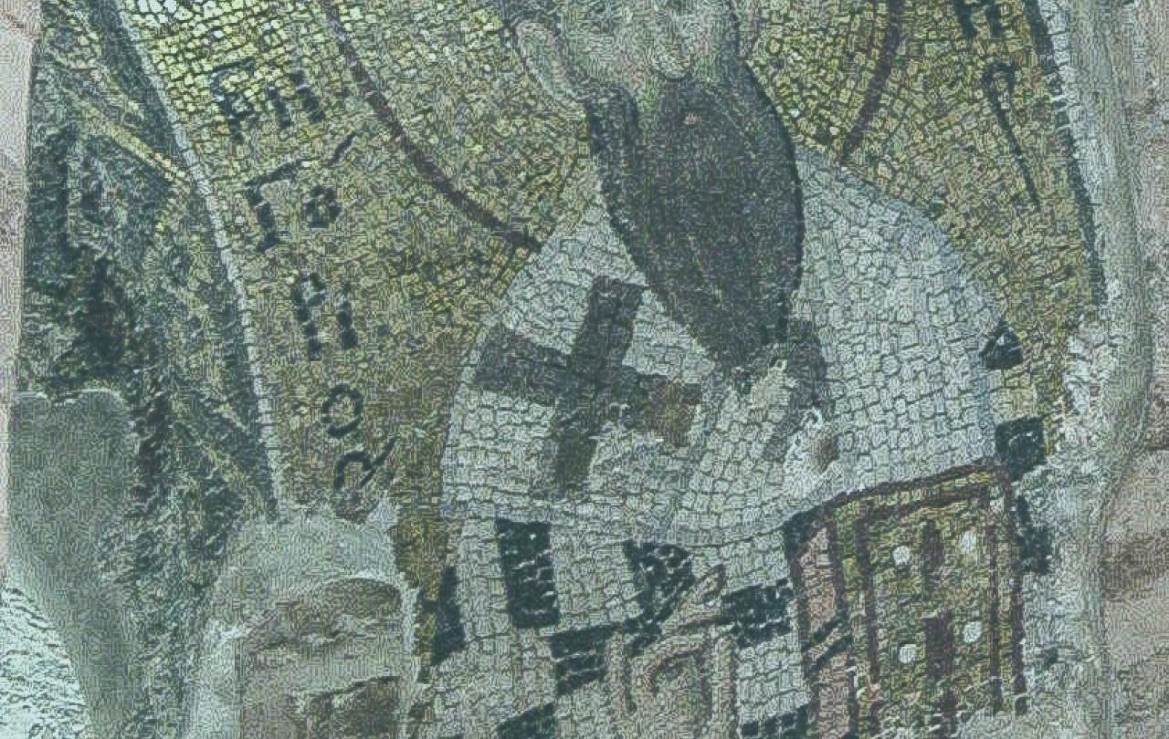 A mosaic shows a saint with a beard holding a bible and his hand held up in a blessing.