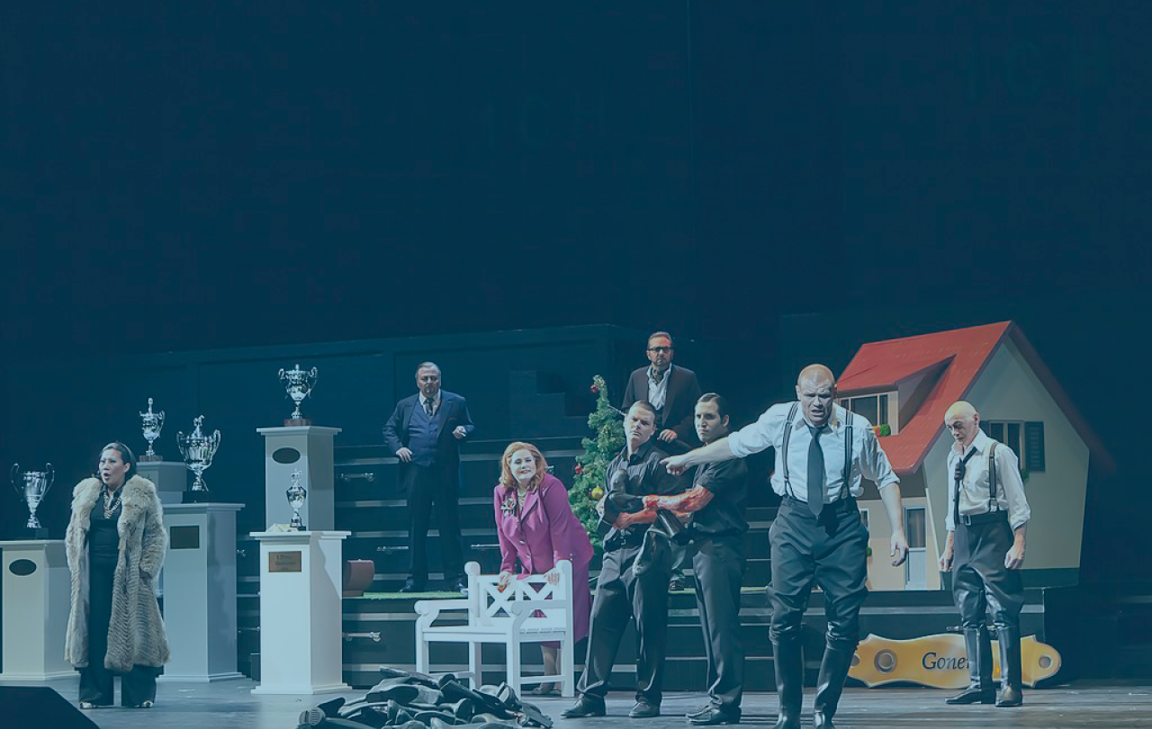 A modern staging of King Lear has the cast across the page. King Lear is front of stage gesturing while the others look on