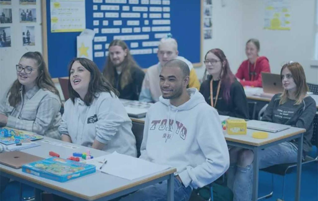 Students sit in a classroom.