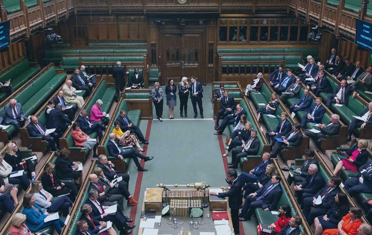 an aerial view down in to the parliamentary chamber shows MPs sitting on benches on the left and right hand side