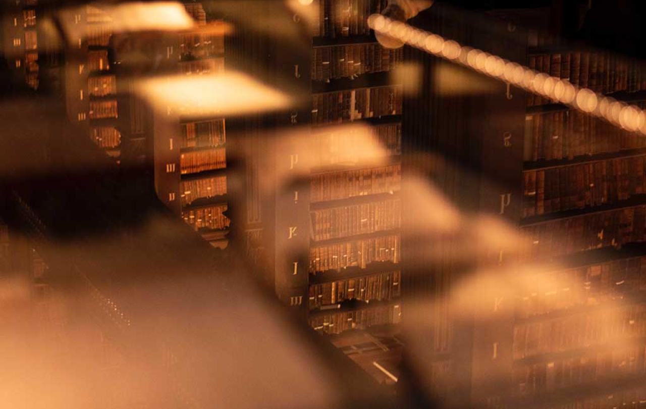 An unfocused views down on to stacks of books in an old library.