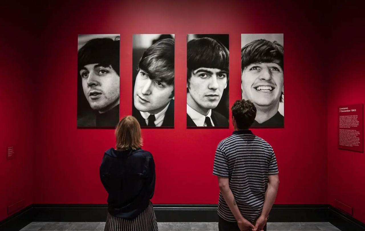 Two gallery vistor stair at four photo portraits of The Beatles.