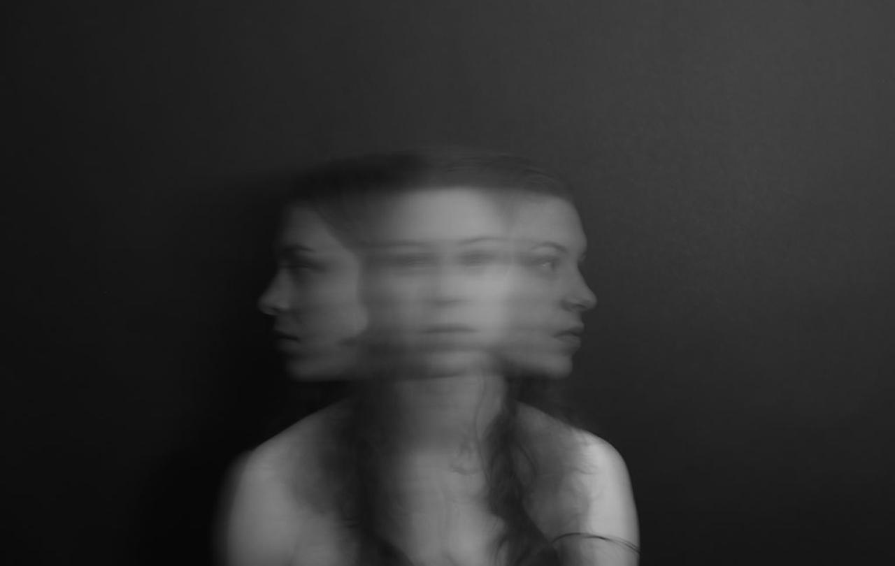 A blurred multiple exposure shows a woman turning her head from side to side.