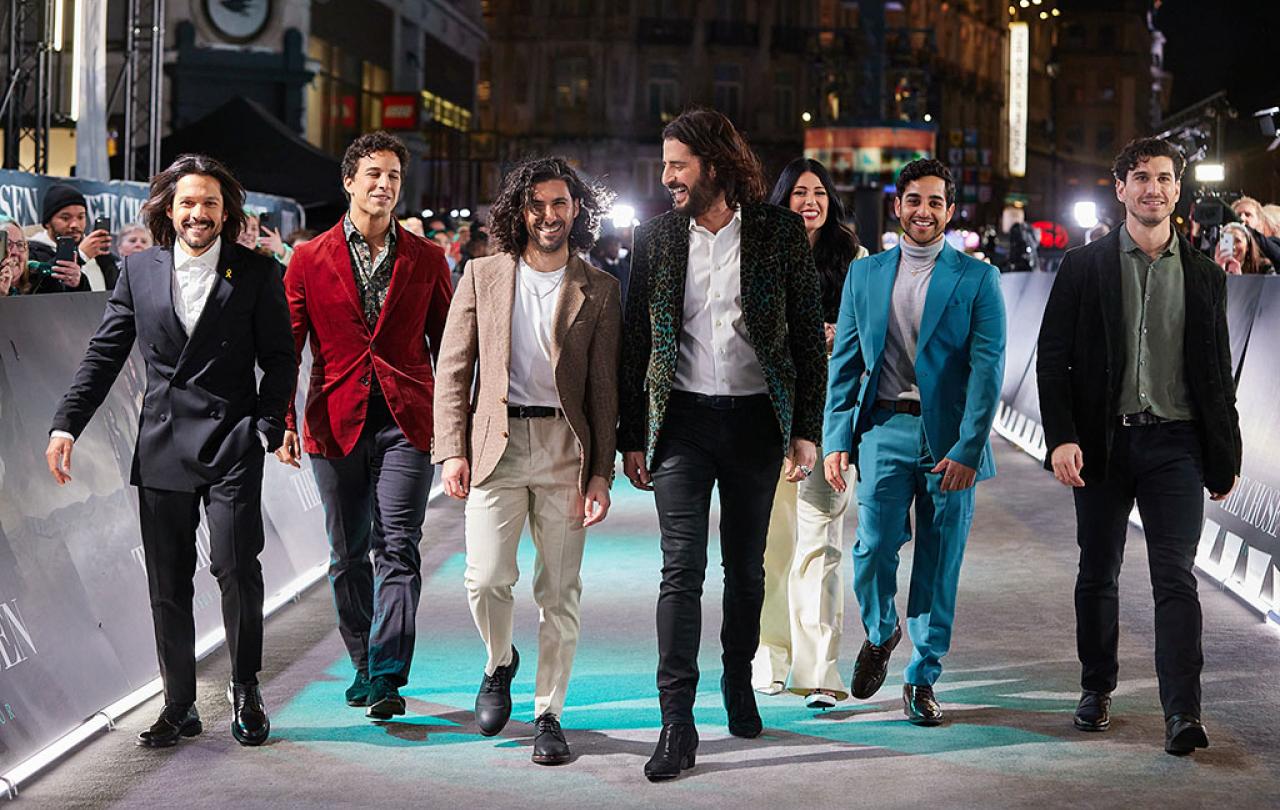 A group of actors walk together at a film premiere