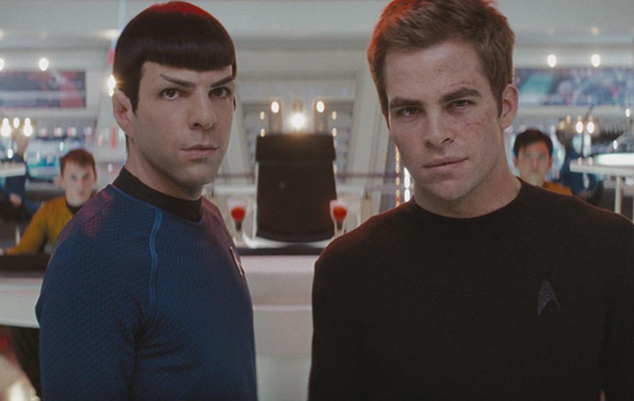 Spock and Kirk stand on the bridge of a spacecraft.