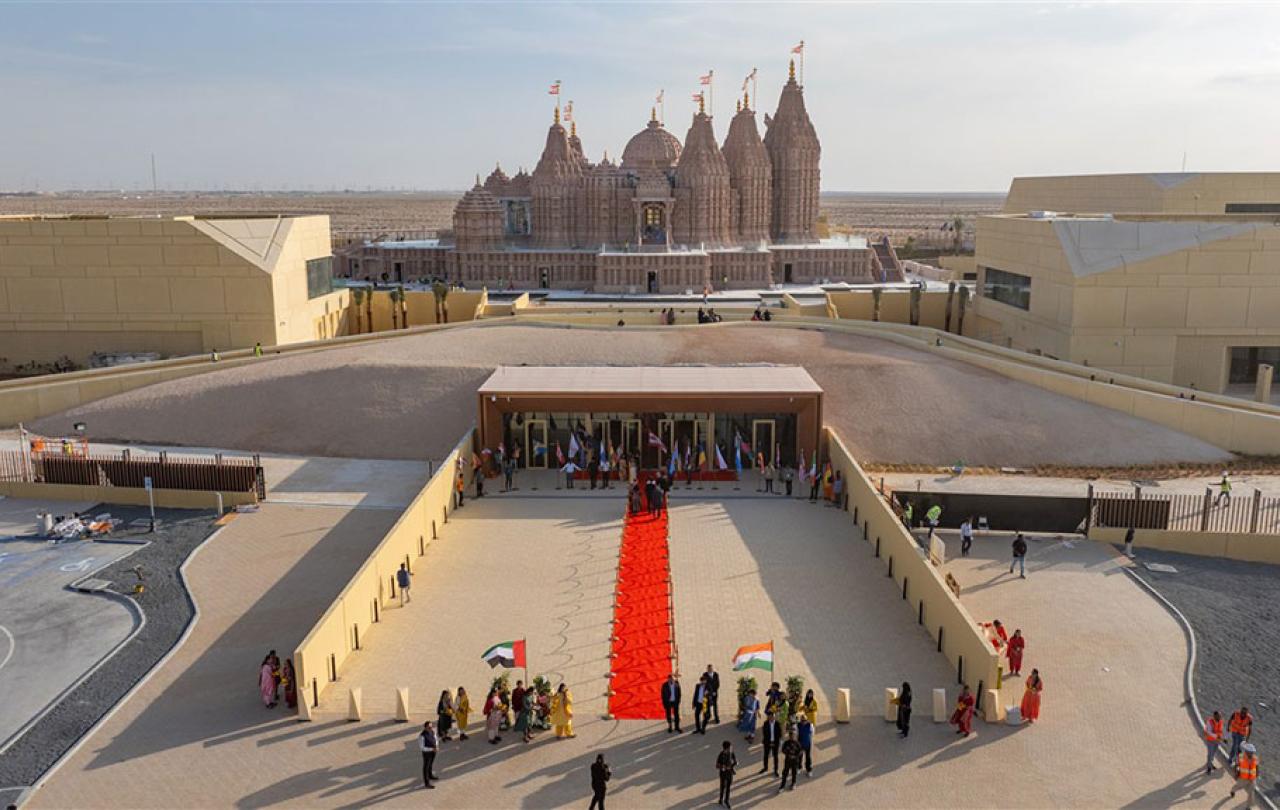 A red carpet lies on a grand entrance to a newly constructed Hindu temple.