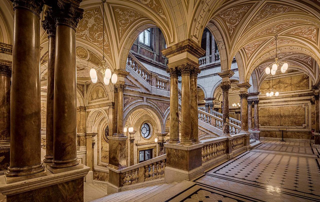 A marbles staircase rises on four sides of a chamber.