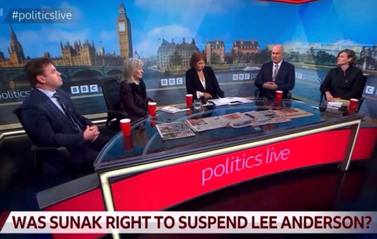 A TV roundtable discussion with five people against a backdrop of Parliament.