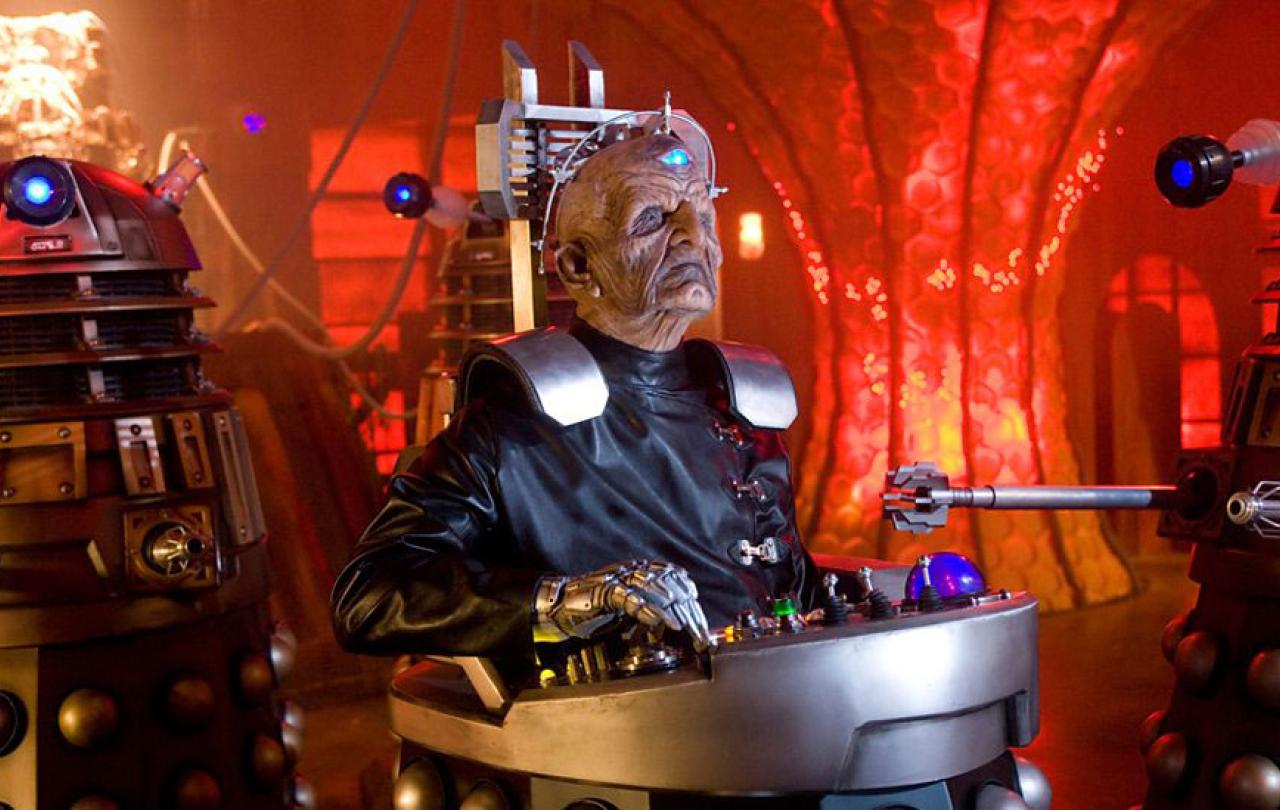 Davros, an alien leader sits in the lower half of a Dalek.