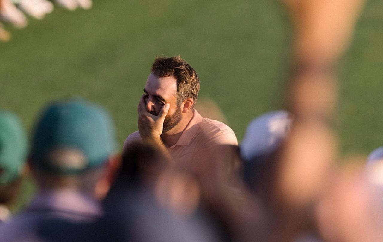 A golfer cups his face as he realises he has won.