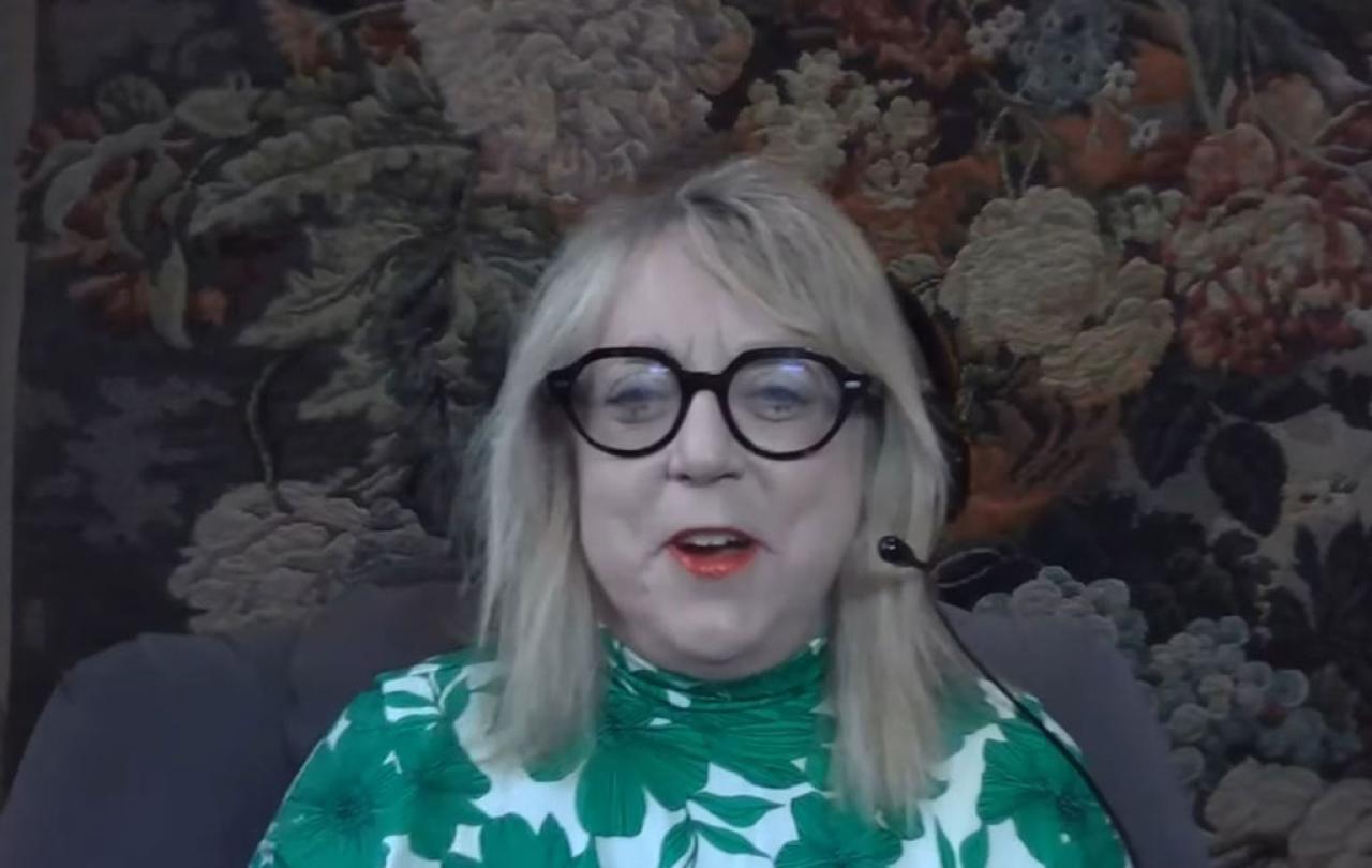 A woman guest on a podcast laughs.