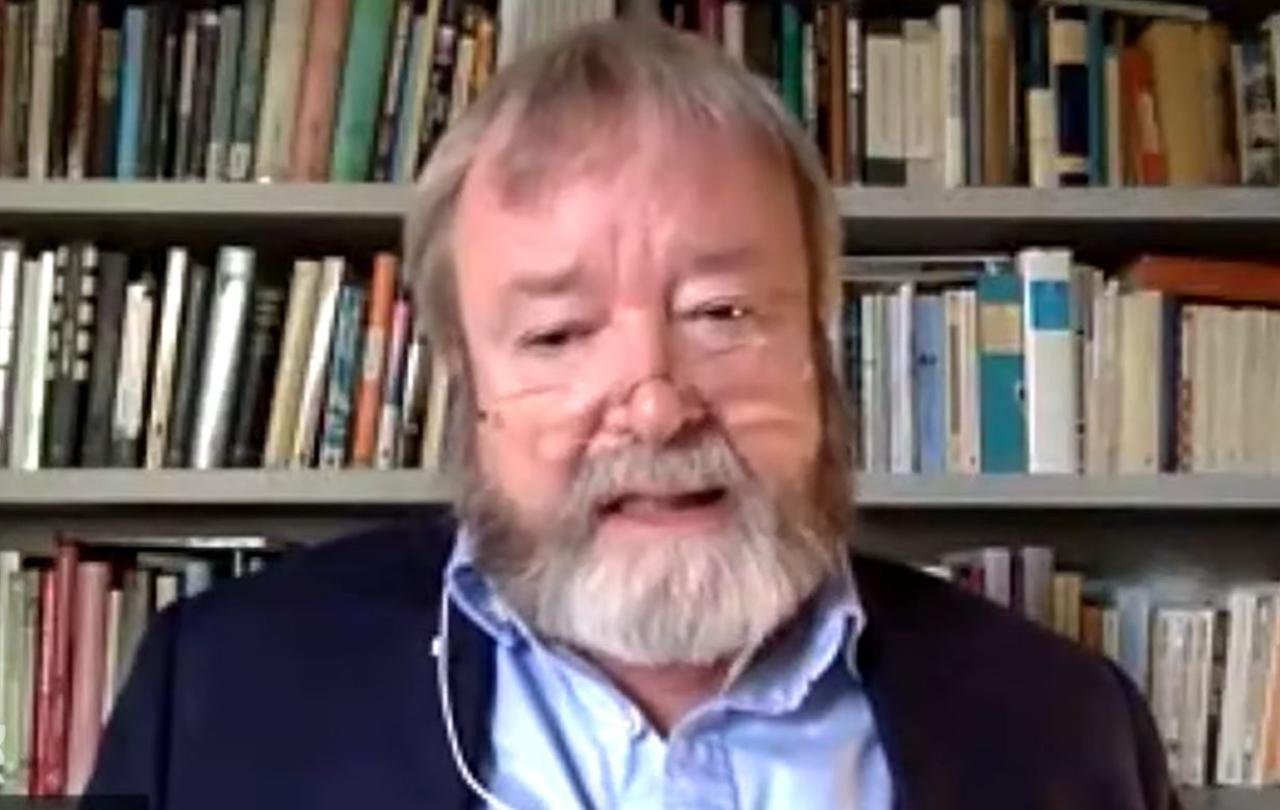 A man sits and talks to the camera.