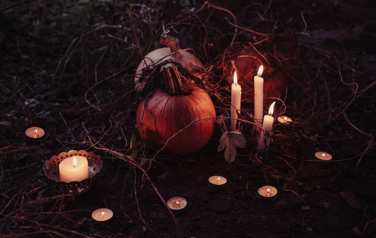 pumpkin between lighted candles
