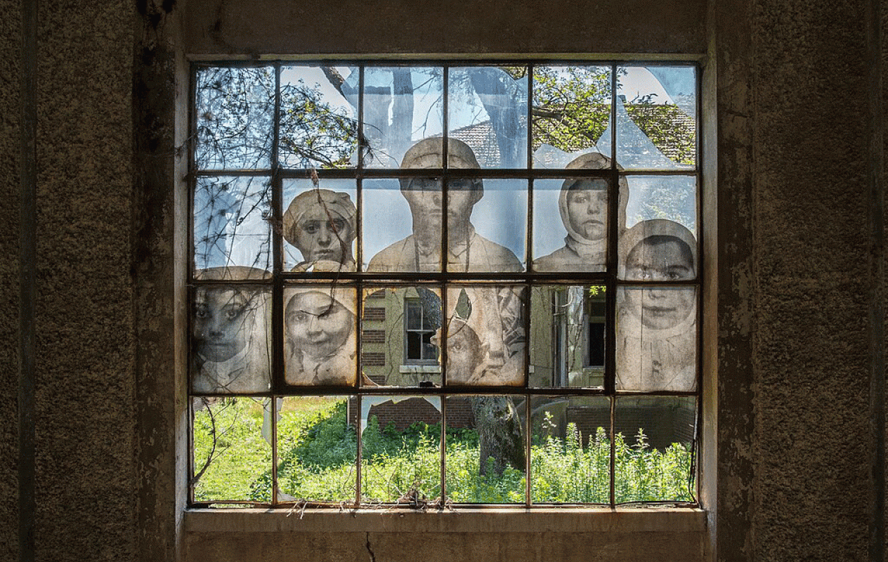 a multi-paned window mural shows people while amid it are broken window panes.