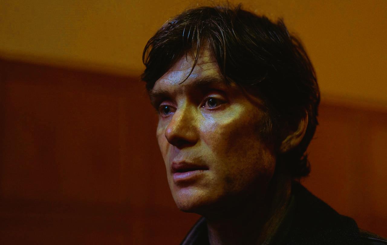 The gaunt face of a dishevelled man stares into the distance
