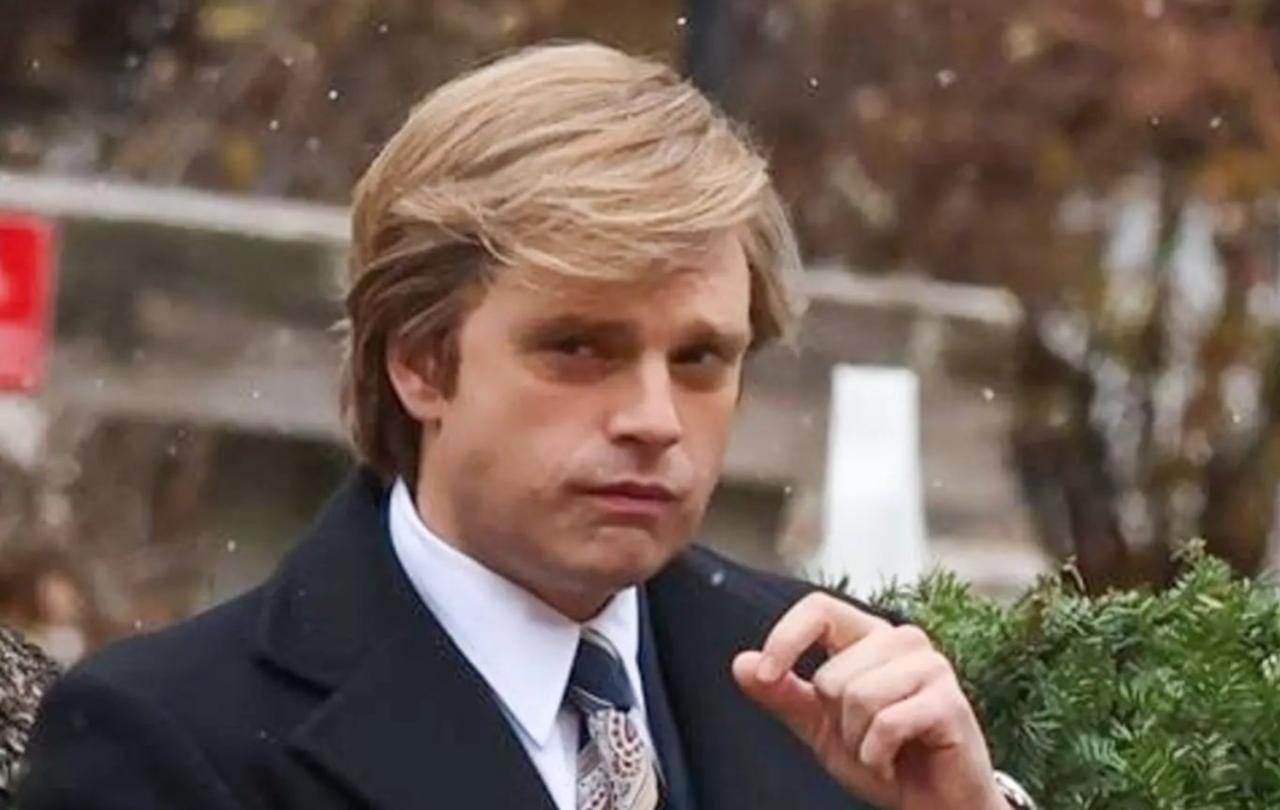 An 1980s business man looks contemptuously at the camera.
