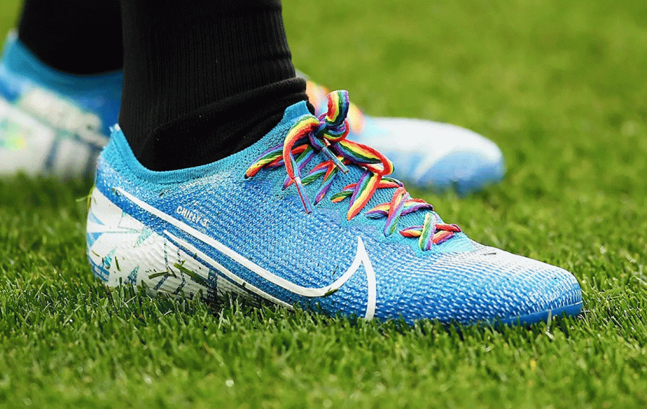 A football boot with rainbow laces