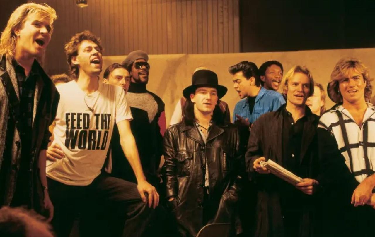 Pop stars sing together while recording a charity single.