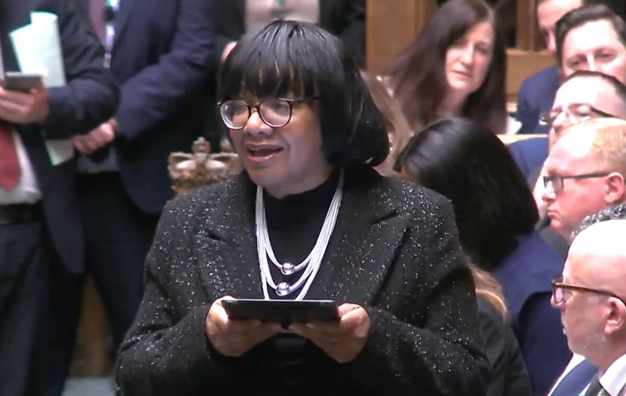 An MP stands and speaks in a parliamentary debate.