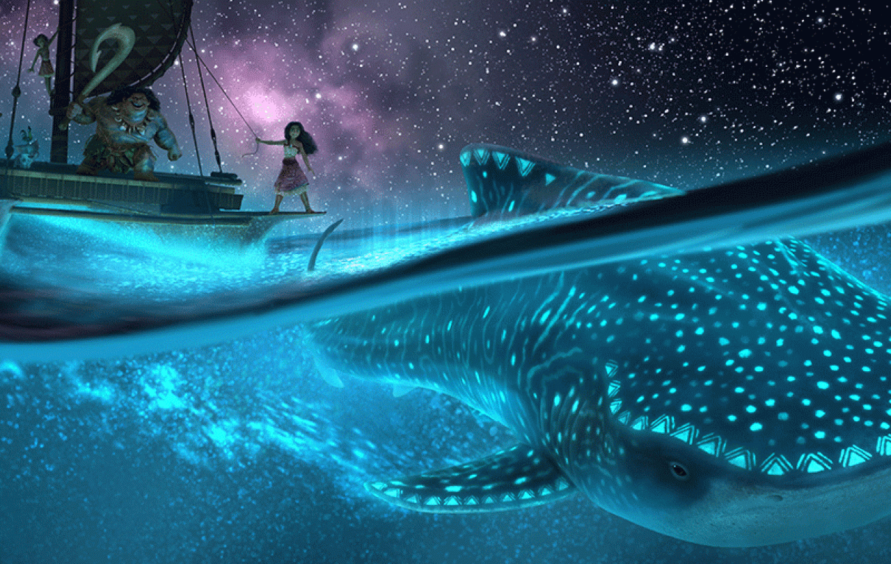 A cartoon still shows a nightscape at sea with a Polynesian style vessel above, with Moana standing on it sailing above a whale illuminated by bioluminescence 