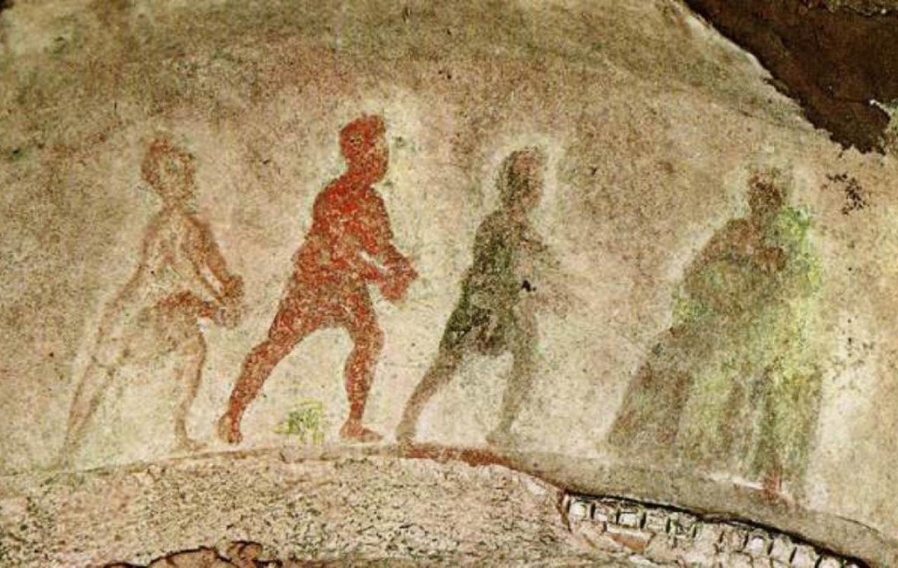 Silhouttes of three wise men approach the Virgin and Child, painted on stone. 
