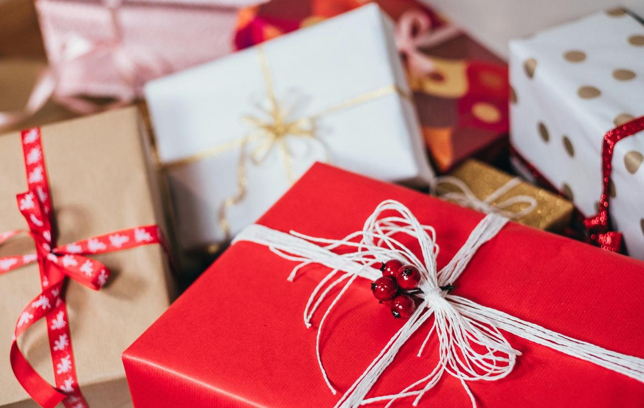 Christmas presents wrapped with red and white paper and string.