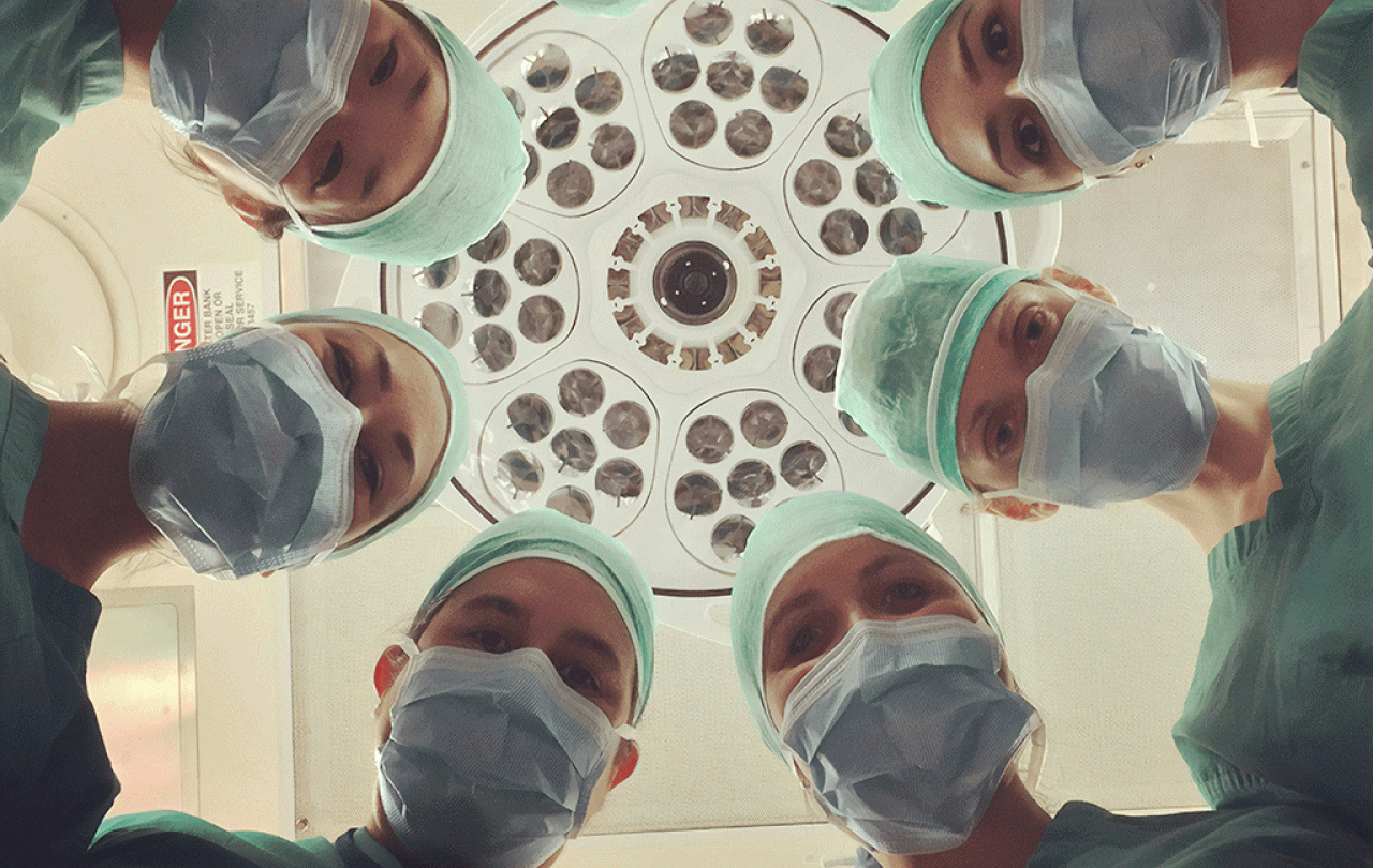 A patient eye view of six surgeons looking down.