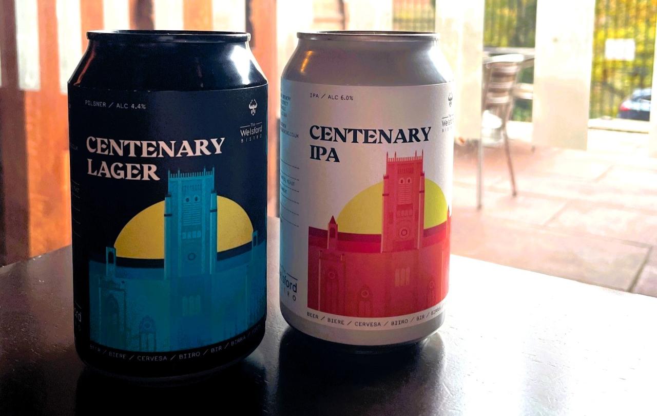 Two cans of beer depict a drawing of a cathedral.
