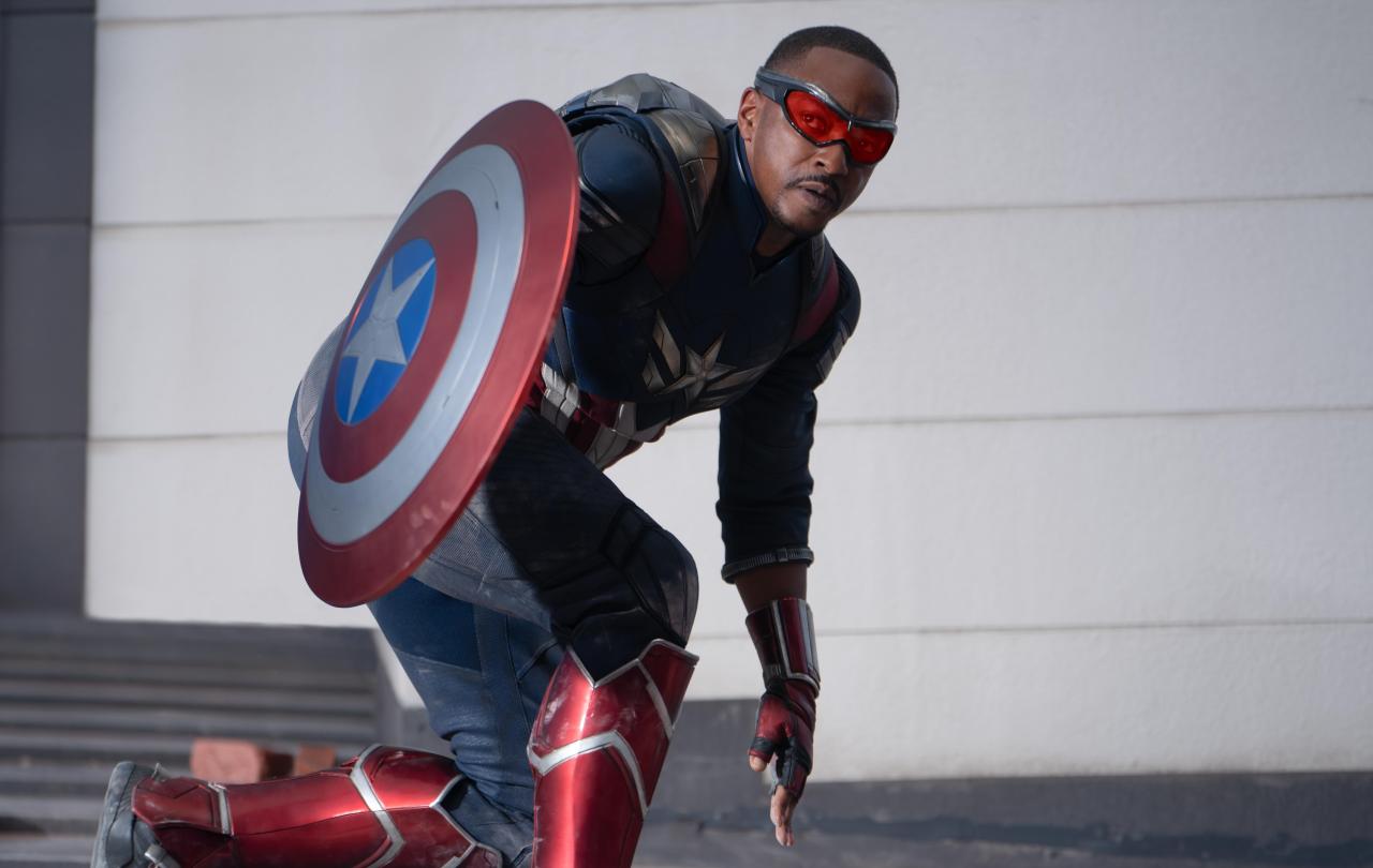 Captain America crouches expectantly beside his shield