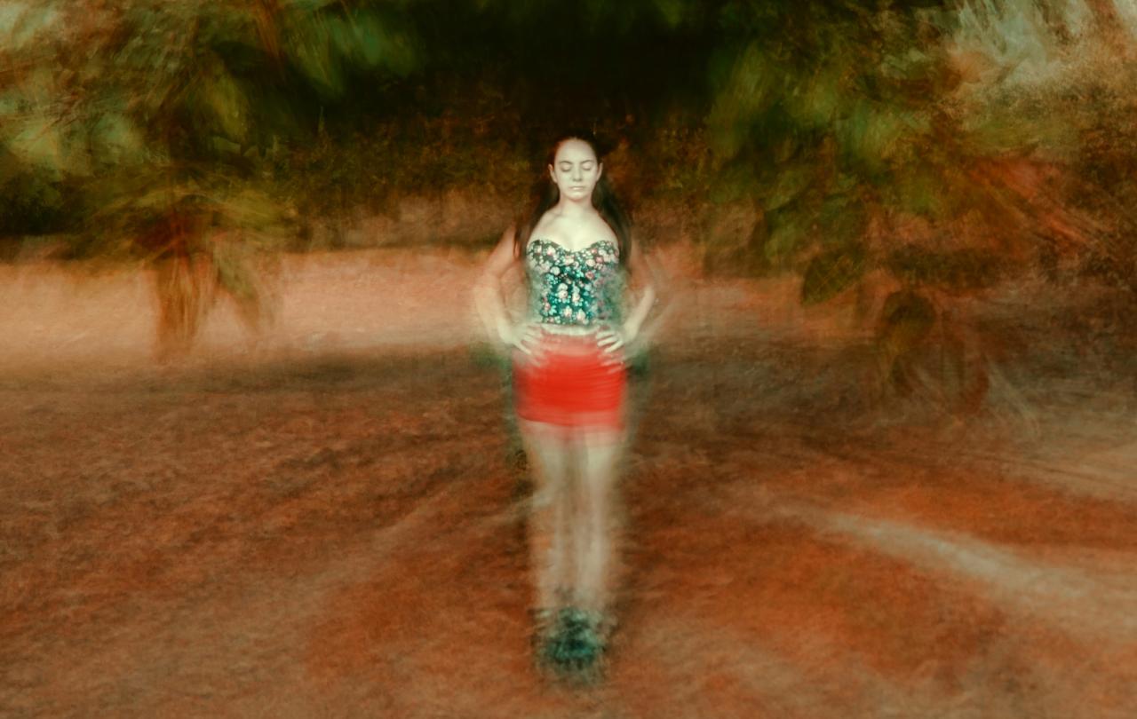 A montage image places a woman, with eyes shut and hands on hip, at the centre of blurred circle of ground and tree branches.