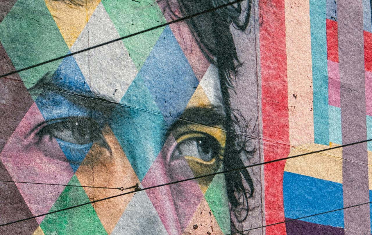A colorful mural depicts the eyes of Bob Dylan staring to the side.